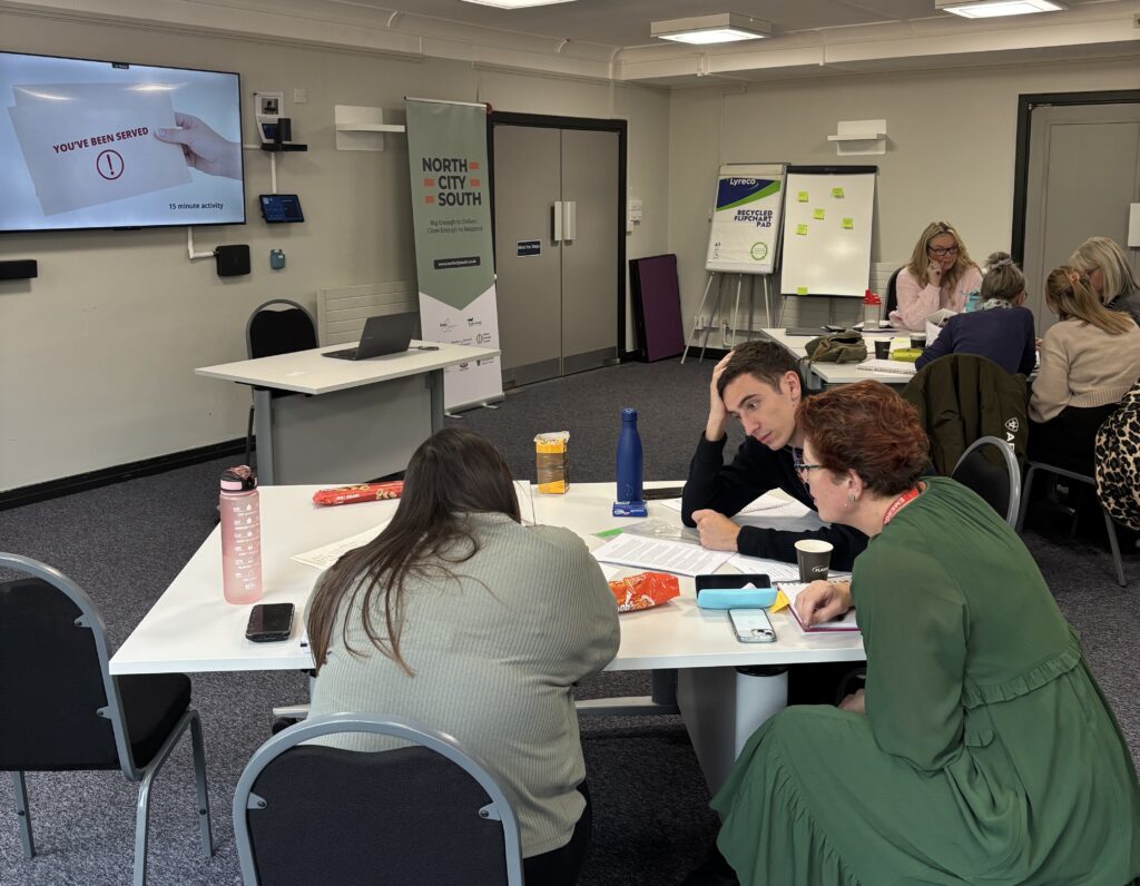 Participants working on a task together at the Debt Course in Blaby